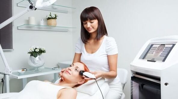 a specialist conducts a skin rejuvenation session with an apparatus